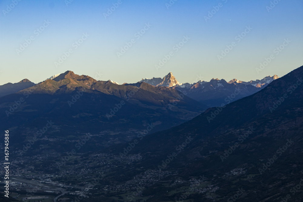 Sunrise on the tops of the mountains above Aosta Valley