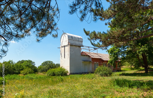 Old tower solar telescope with a closed retractable roof