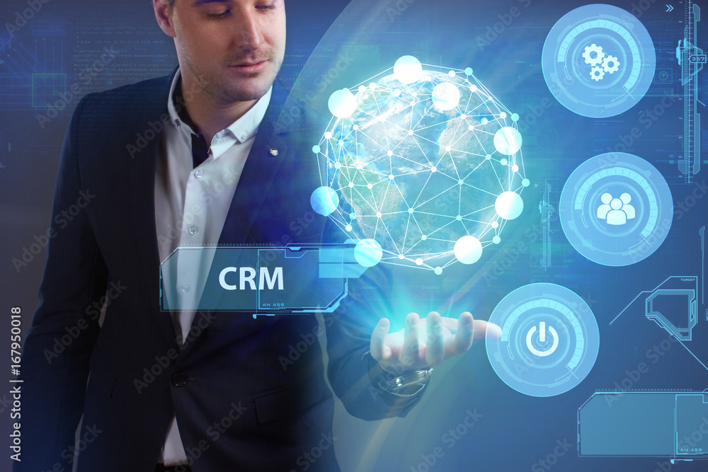 Business, Technology, Internet and network concept. Young businessman working on a virtual screen of the future and sees the inscription: CRM Business, Technology, Internet and network concept. Young businessman working on a virtual screen of the future and sees the inscription: CRM