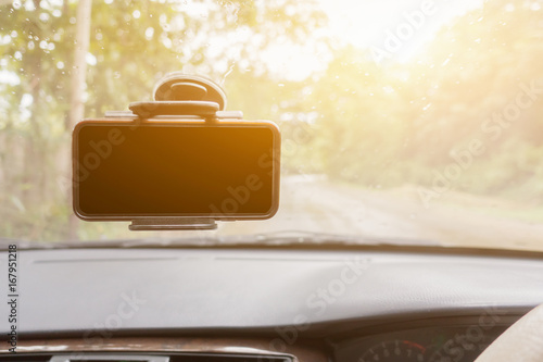 mobile phone with blank screen in car windshield holder,vintage color,selective focus