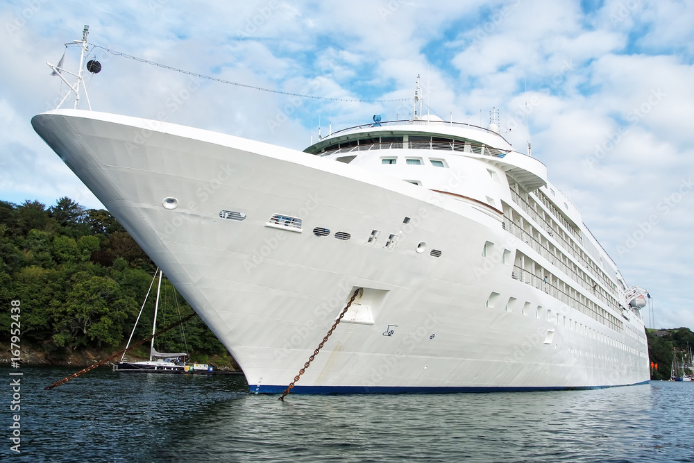 Large luxury white cruise ship liner at Fowey