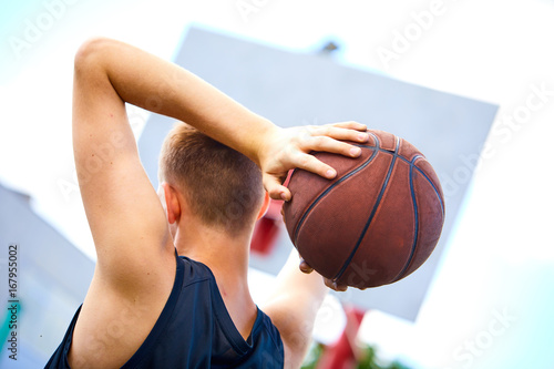 male playing basketball outdoor