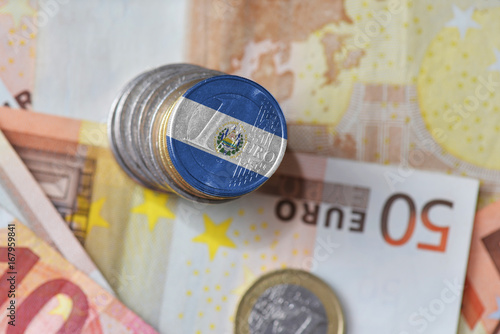 euro coin with national flag of el salvador on the euro money banknotes background.