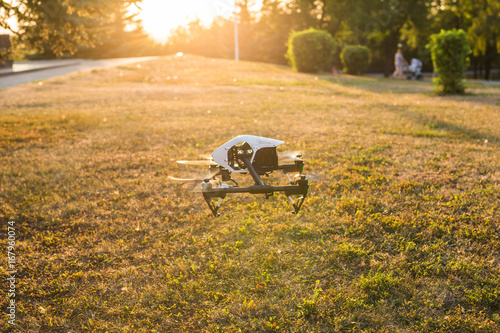 White drone, quadrocopter with photo camera flying