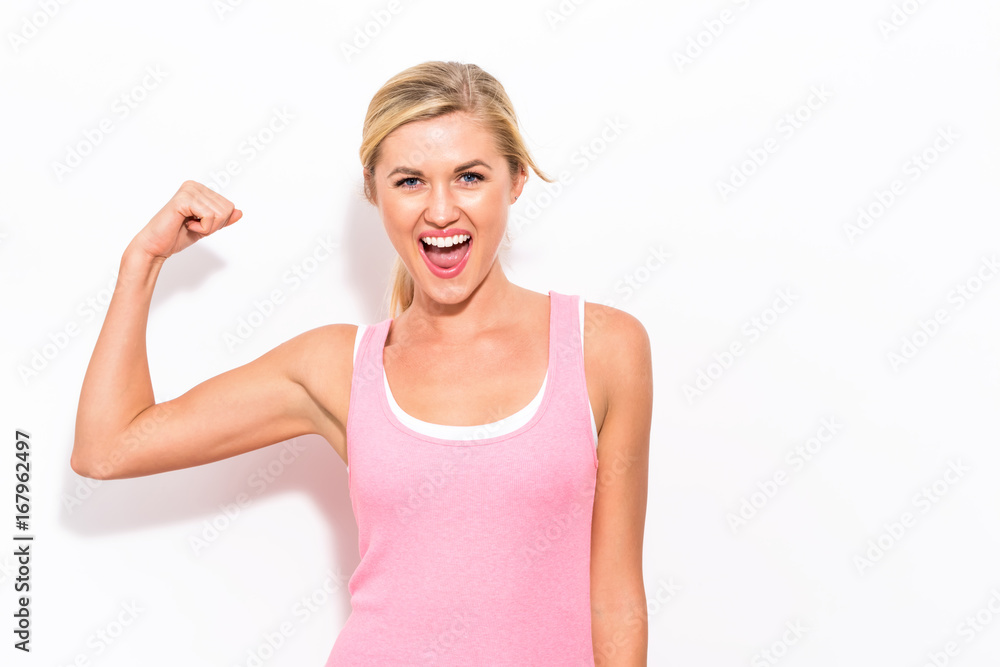 Powerful young fit woman on a white background - obrazy, fototapety, plakaty 