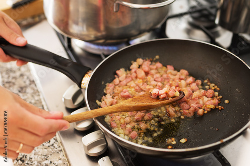 Preparation of bacon with onions in a frying pan