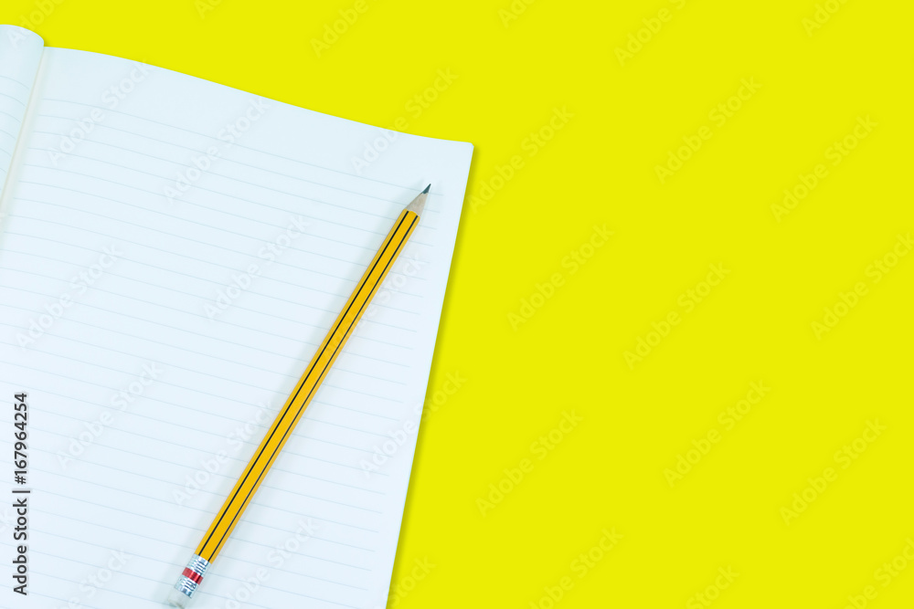 Notebook with pencil isolate on yellow background,for art education background Notebook with pencil isolate on yellow background,for art education background