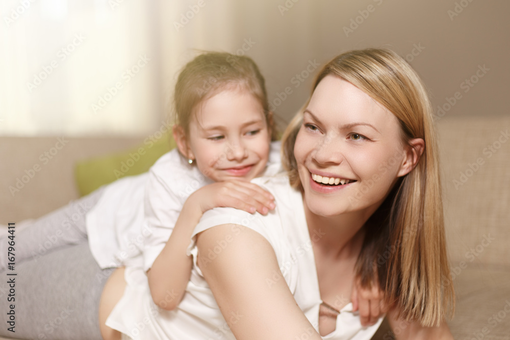 Mum and her cute daughter child girl are playing, smiling and hugging. Happy mother's day. Family holiday and togetherness. Mum and her cute daughter child girl are playing, smiling and hugging. Happy mother's day. Family holiday and togetherness.