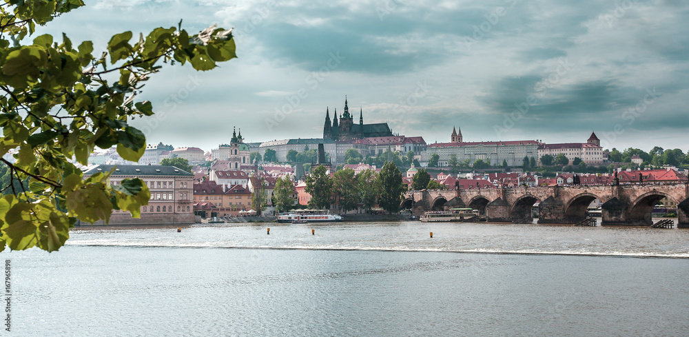 View of the Old Town, Prague Castle, St. Vitus Cathedral, the Charles Bridge and the river Vltava. Vertical shot. Cityscape with dramatic sky. Travel Czech Republic. Europe. View of the Old Town, Prague Castle, St. Vitus Cathedral, the Charles Bridge and the river Vltava. Vertical shot. Cityscape with dramatic sky. Travel Czech Republic. Europe.