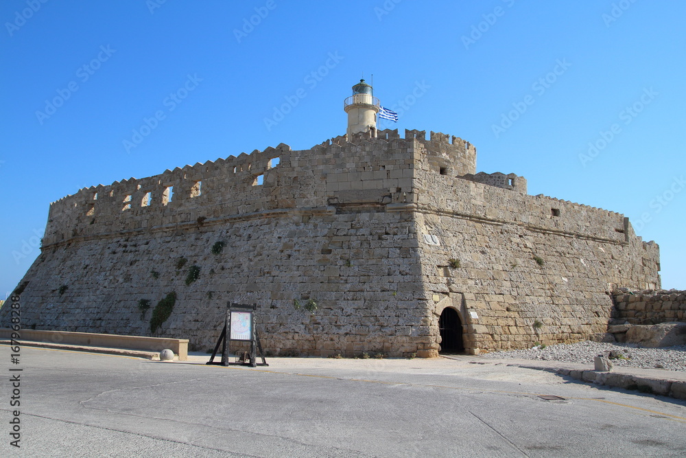 Castle in Mandraki harbour in Rhodes, Greece