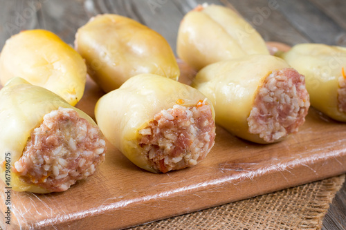 Raw stuffed peppers on a cutting board photo