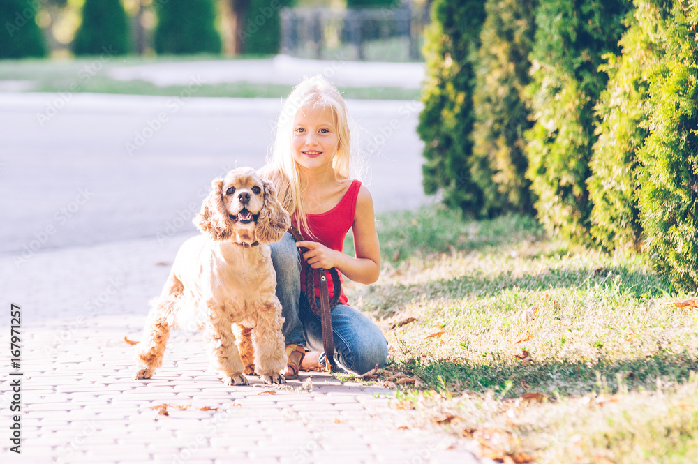 Little beautiful girl is walking with a dog in the park Little beautiful girl is walking with a dog in the park