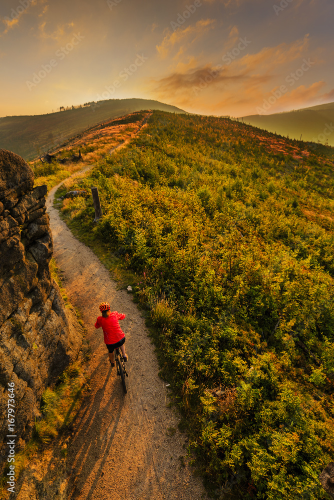 Mountain biking women riding on bike in summer mountains forest landscape. Woman cycling MTB flow trail track. Outdoor sport activity.
