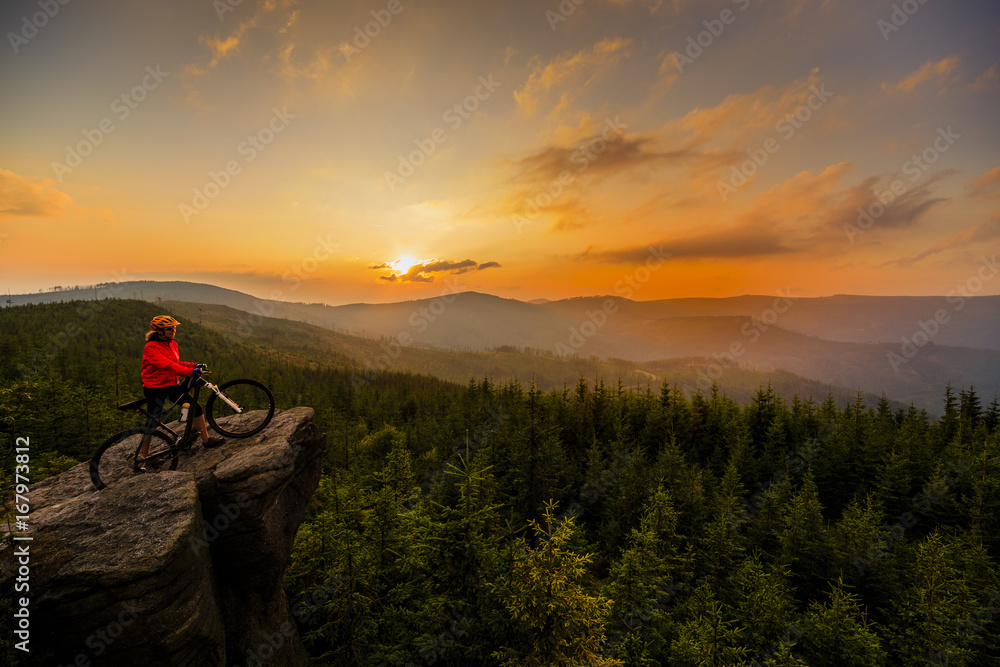 Mountain biking women riding on bike in summer mountains forest landscape. Woman cycling MTB flow trail track. Outdoor sport activity. Mountain biking women riding on bike in summer mountains forest landscape. Woman cycling MTB flow trail track. Outdoor sport activity.