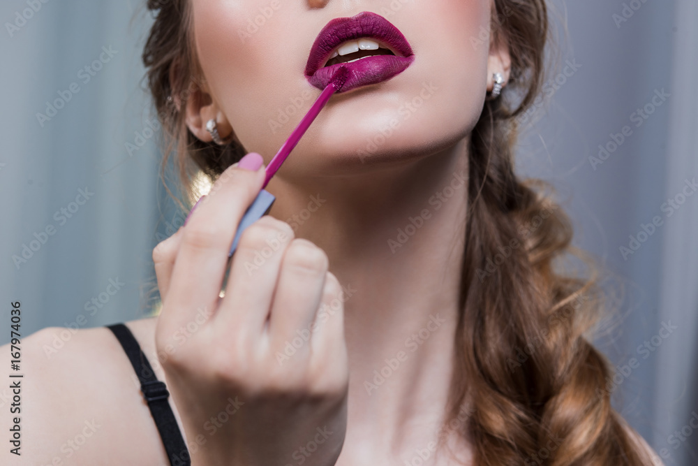 Advertising lipstick, lip gloss, makeup, beautiful, girl, paints, smears lipstick bright purple, pink, mouth open, professional makeup, retouching, close-up Advertising lipstick, lip gloss, makeup, beautiful, girl, paints, smears lipstick bright purple, pink, mouth open, professional makeup, retouching, close-up