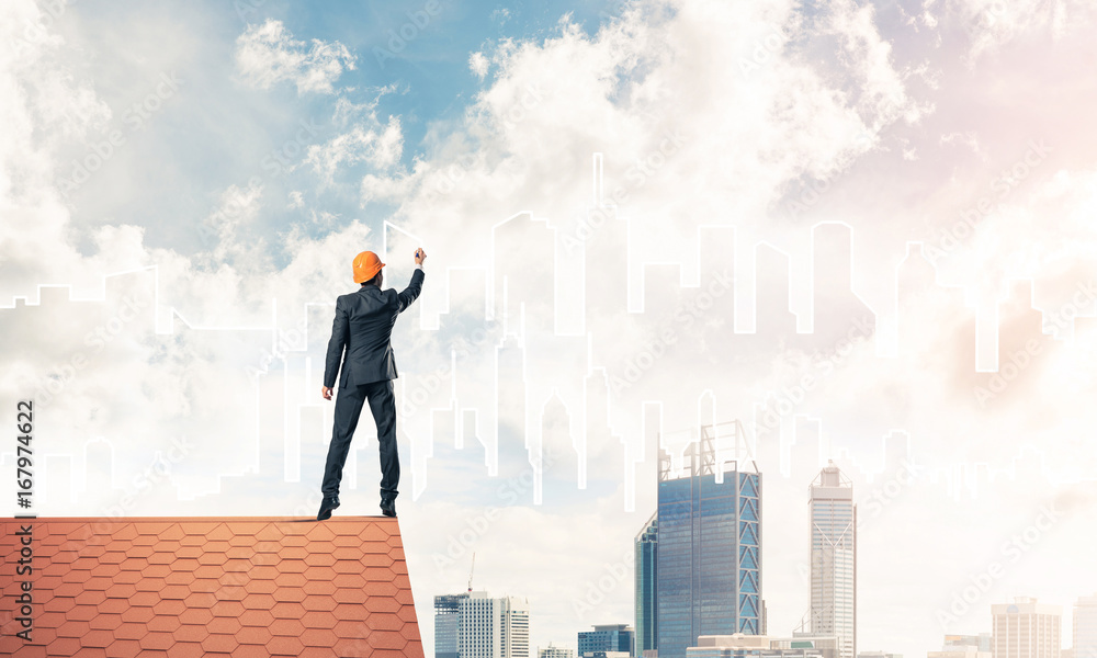Man architect draw silhouette of modern city on blue sky. Mixed Man architect draw silhouette of modern city on blue sky. Mixed