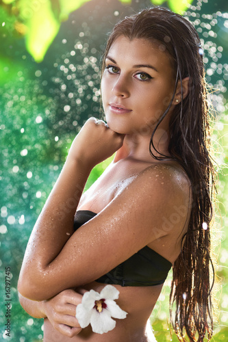Quadro em tela Beautiful young woman in the rain at hot summer day