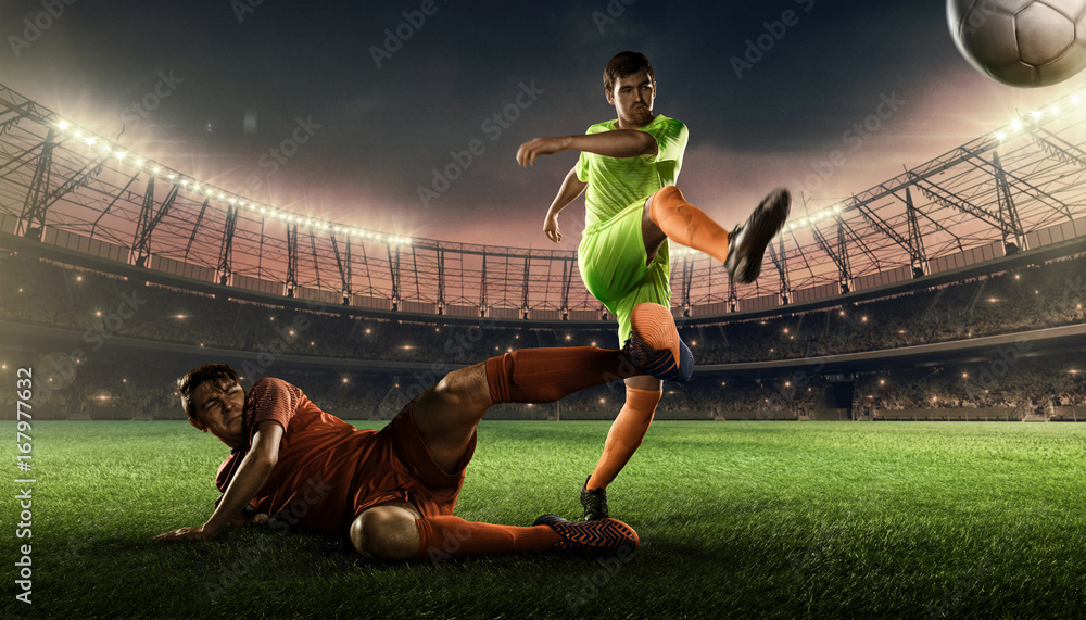 two soccer players on a soccer field fighting for a ball 