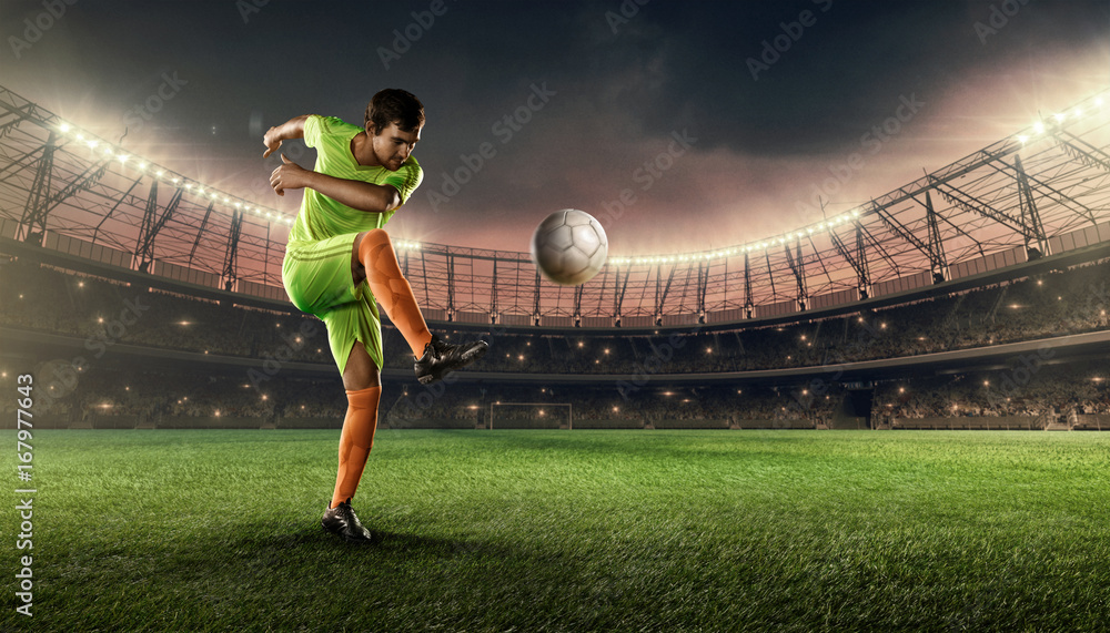 soccer player hits a ball on a soccer stadium with illumination lights and dramatic night sky