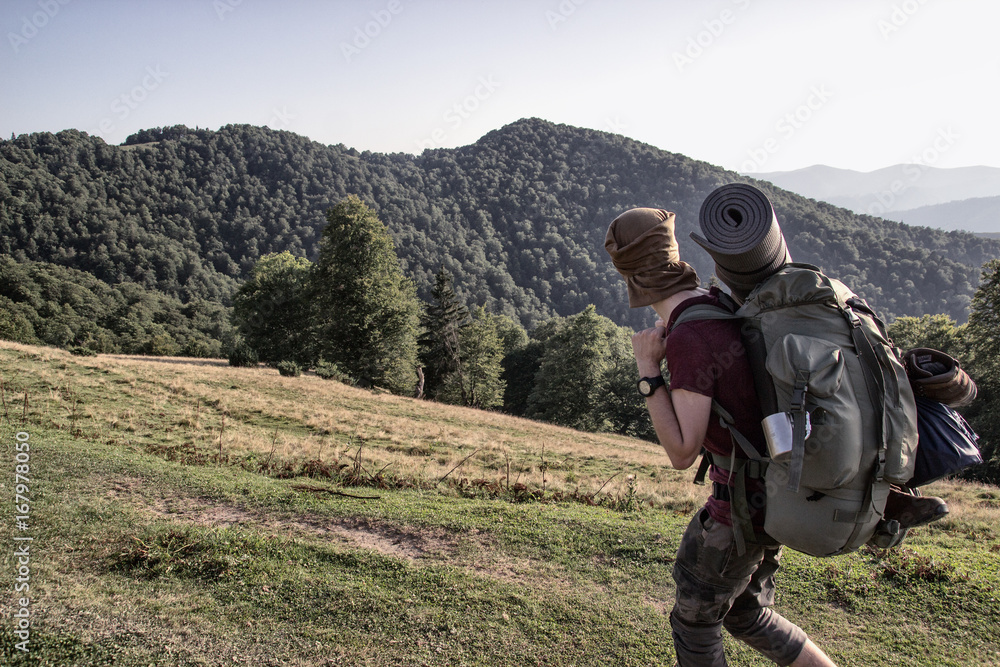 A soldier with  a backpack
 in the mountians