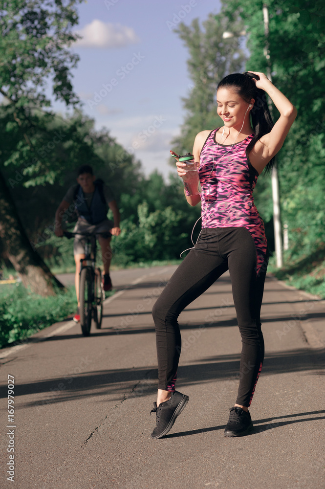 Young woman is thirsty for drinking water for recovery after running Young woman is thirsty for drinking water for recovery after running