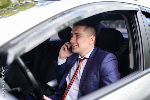 Man talking on the phone in the car. © fotofrol