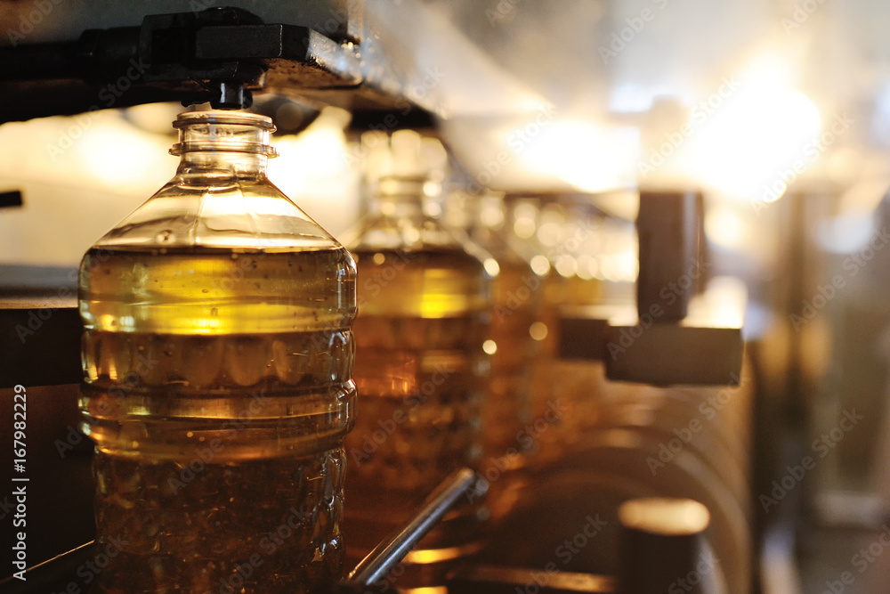 Sunflower oil production plant. Bottling line of vegetable oil in bottles