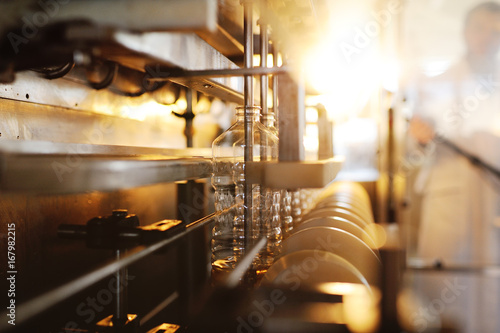 Fotografie Sunflower oil in the bottle moves along the conveyor line