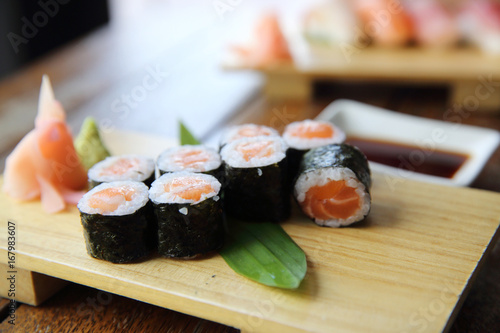 Fotografie, Obraz Salmon maki sushi on wood background , Japanese food