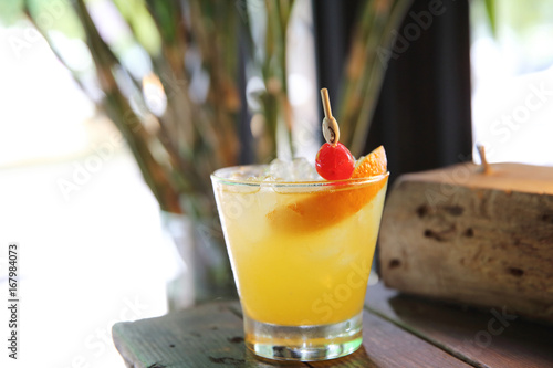 mai tai cocktail with orange cherry fruits on wood background photo