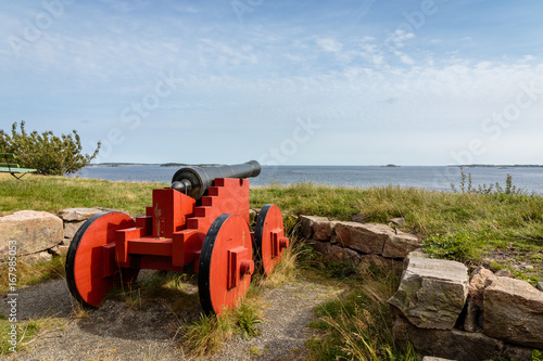 Cannons standing on Odderoya, Kristiansand, Norway. View to the sea, blue sky photo