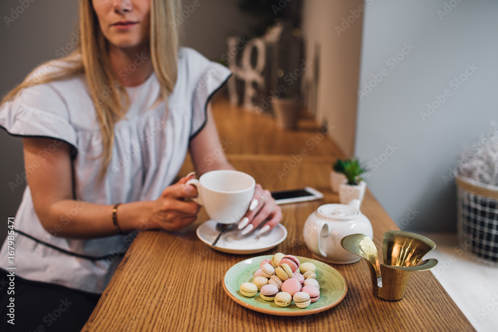 Beautiful girl with hot drink relaxing in  a cafe