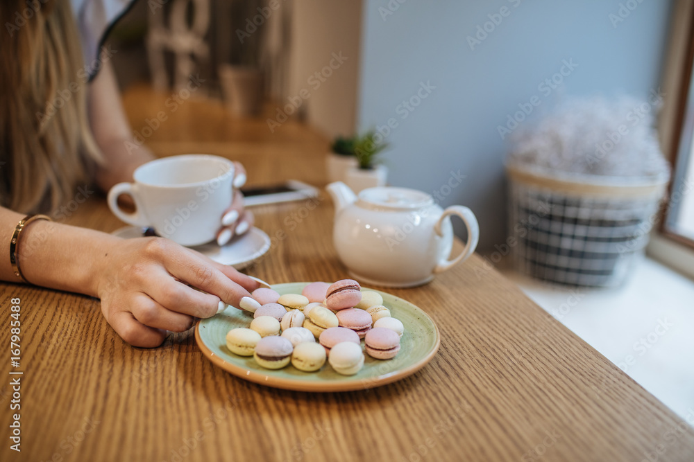 Beautiful girl with hot drink relaxing in a cafe Beautiful girl with hot drink relaxing in a cafe