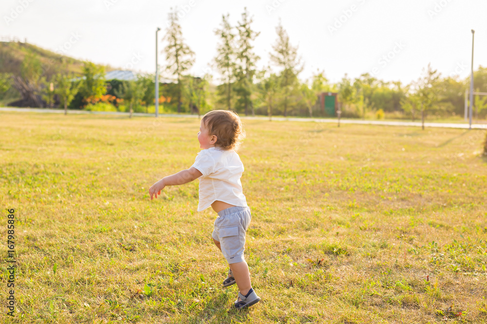 Happy laughing baby boy playing on summer or autumn field. Happy laughing baby boy playing on summer or autumn field.