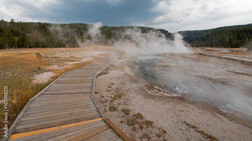 Boardwalk curving around Hot Cascades hot spring in the Lower Geyser Basin in Yellowstone National Park in Wyoming United States