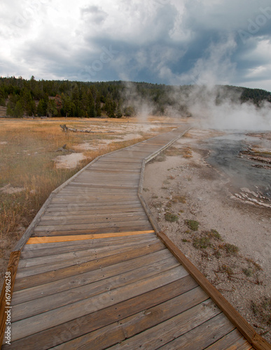 Boardwalk curving around Hot Cascades hot spring in the Lower Geyser Basin in Yellowstone National Park in Wyoming United States