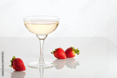 Champagne and strawberries over the glass table