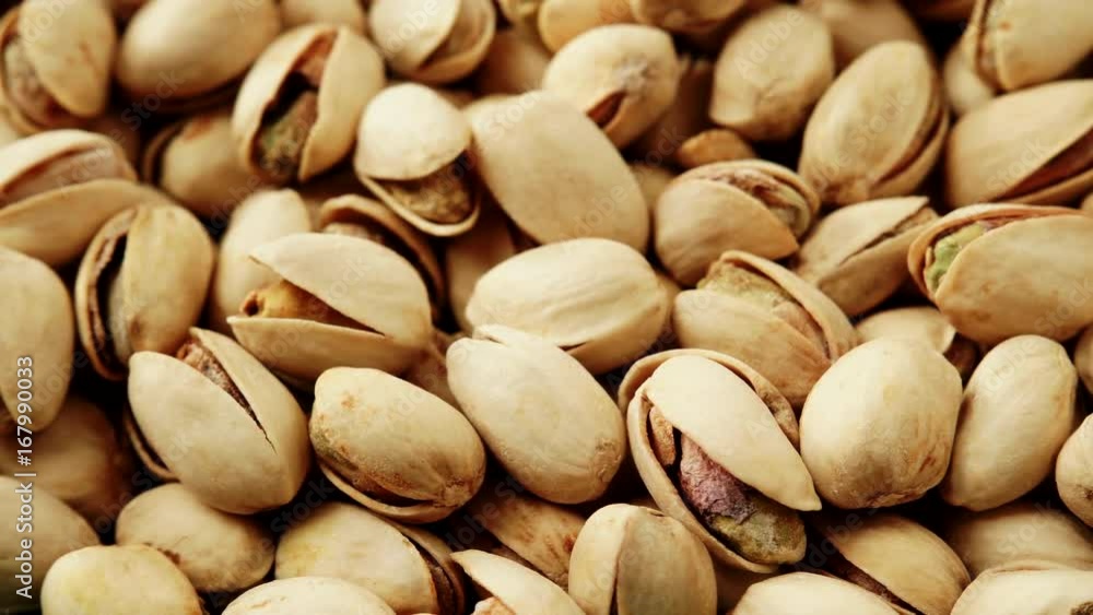 Food background. Roasted pistachio nuts seed with shell close up. Dieting concept. Dolly slider shot 4K ProRes HQ codec Food background. Roasted pistachio nuts seed with shell close up. Dieting concept. Dolly slider shot 4K ProRes HQ codec
