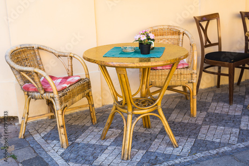 Old fashioned cafe terrace. Tables and wicker chairs in a cafe