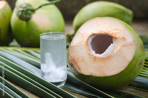coconut juice and drinking sweet coconut water in glass
