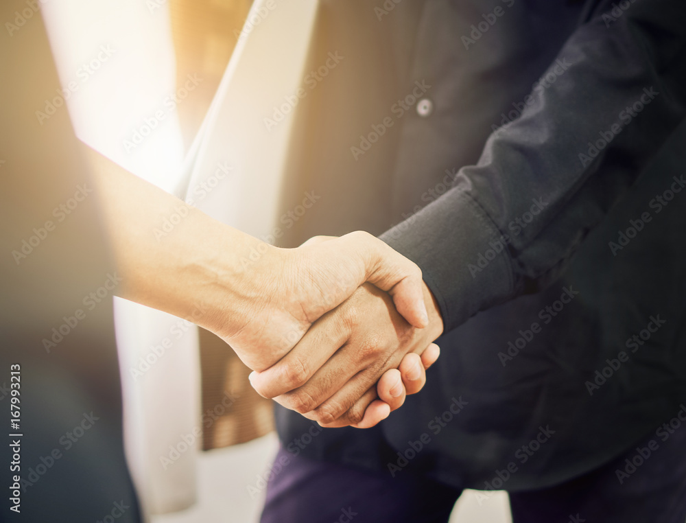 Fototapeta premium Businessmen are shaking hands after successful negotiations in business, The concept of business advancement through collaboration. vintage effect.