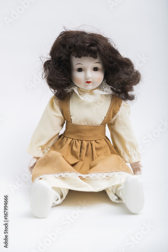 Ceramic porcelain handmade doll with long brunette hair and beige dress