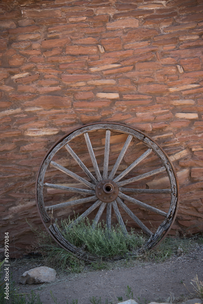 Wooden Wheel on Brick Wall Vertical