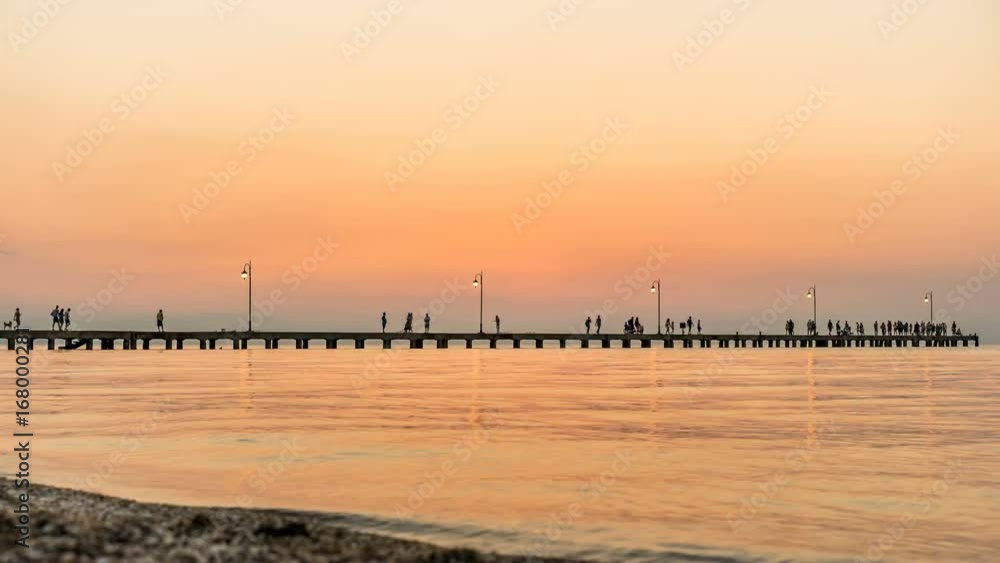 Sea after Sunset at old Jetty with people silhouettes walking and fishing in 4K Sea after Sunset at old Jetty with people silhouettes walking and fishing in 4K