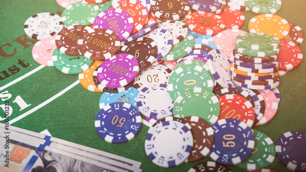 Fototapeta premium Gambling chips and cards on a green cloth Casino table