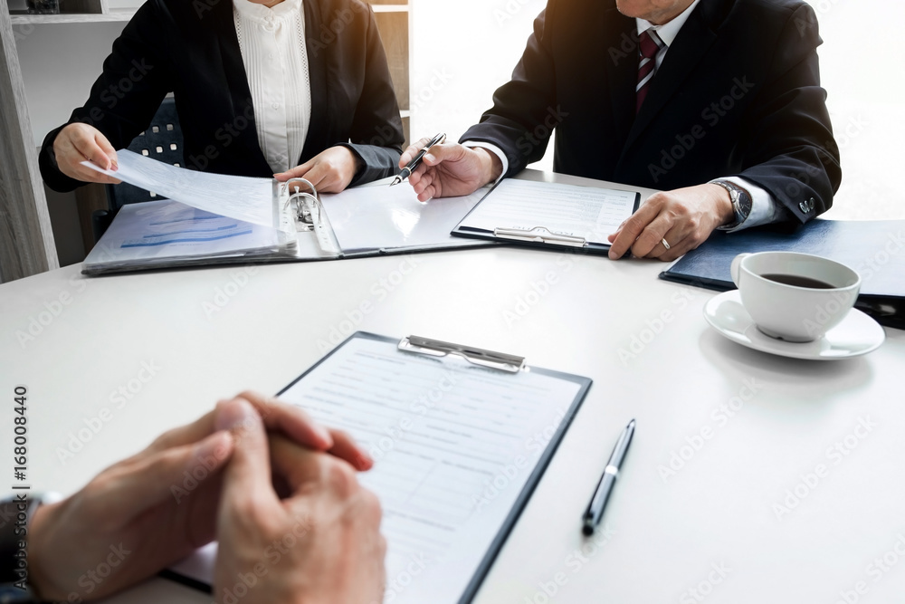 Businessman conducting an interview with businessman in an office Businessman conducting an interview with businessman in an office