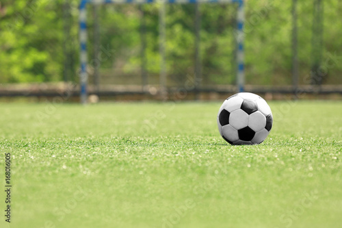 Soccer ball on green grass at the stadium