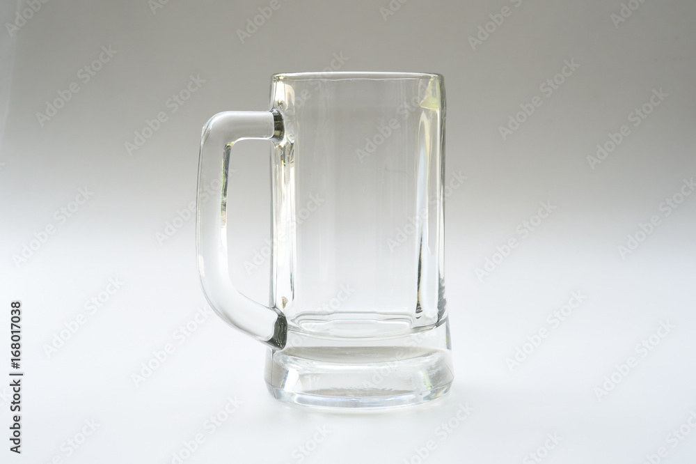 Empty glass for drinks on gray background Empty glass for drinks on gray background