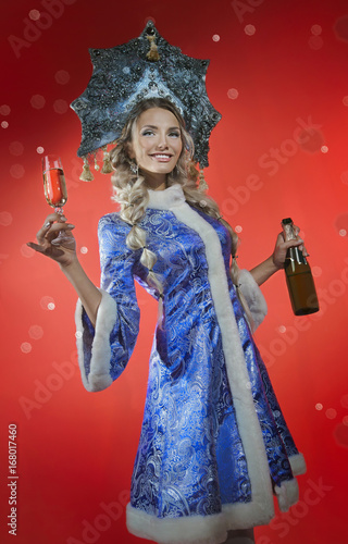 Beautiful snow maiden with a glass of champagne