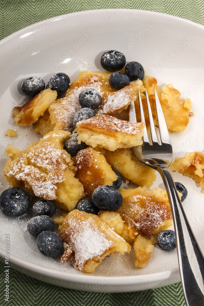 kaiserschmarrn with blueberries sprinkled with powdered sugar kaiserschmarrn with blueberries sprinkled with powdered sugar